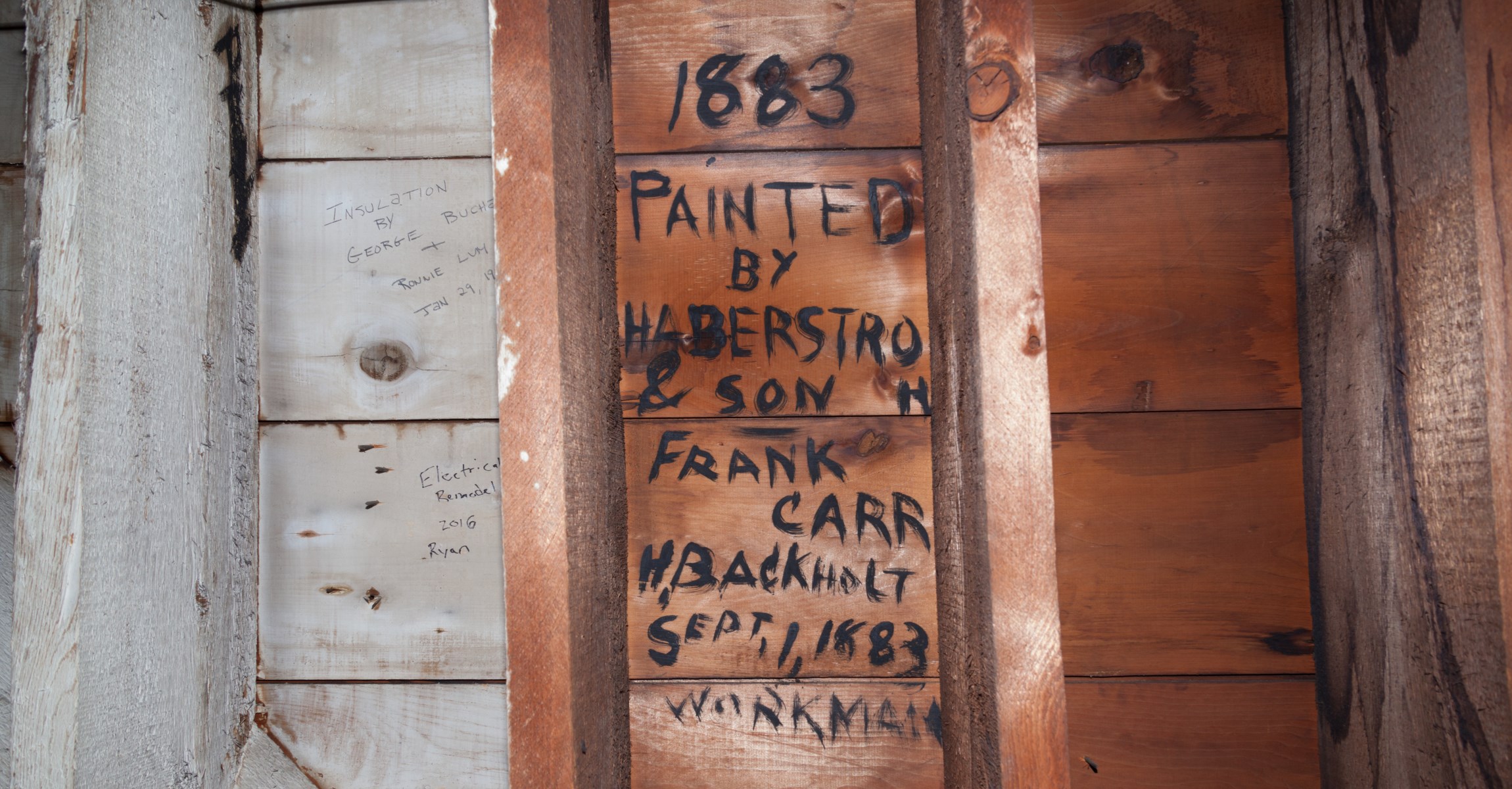 Black writing on wooden wall between rafters, text reads: 1883 Painted by Haberstroh & Son Frank Carr H. Backholt Sept 1, 1883 Workman