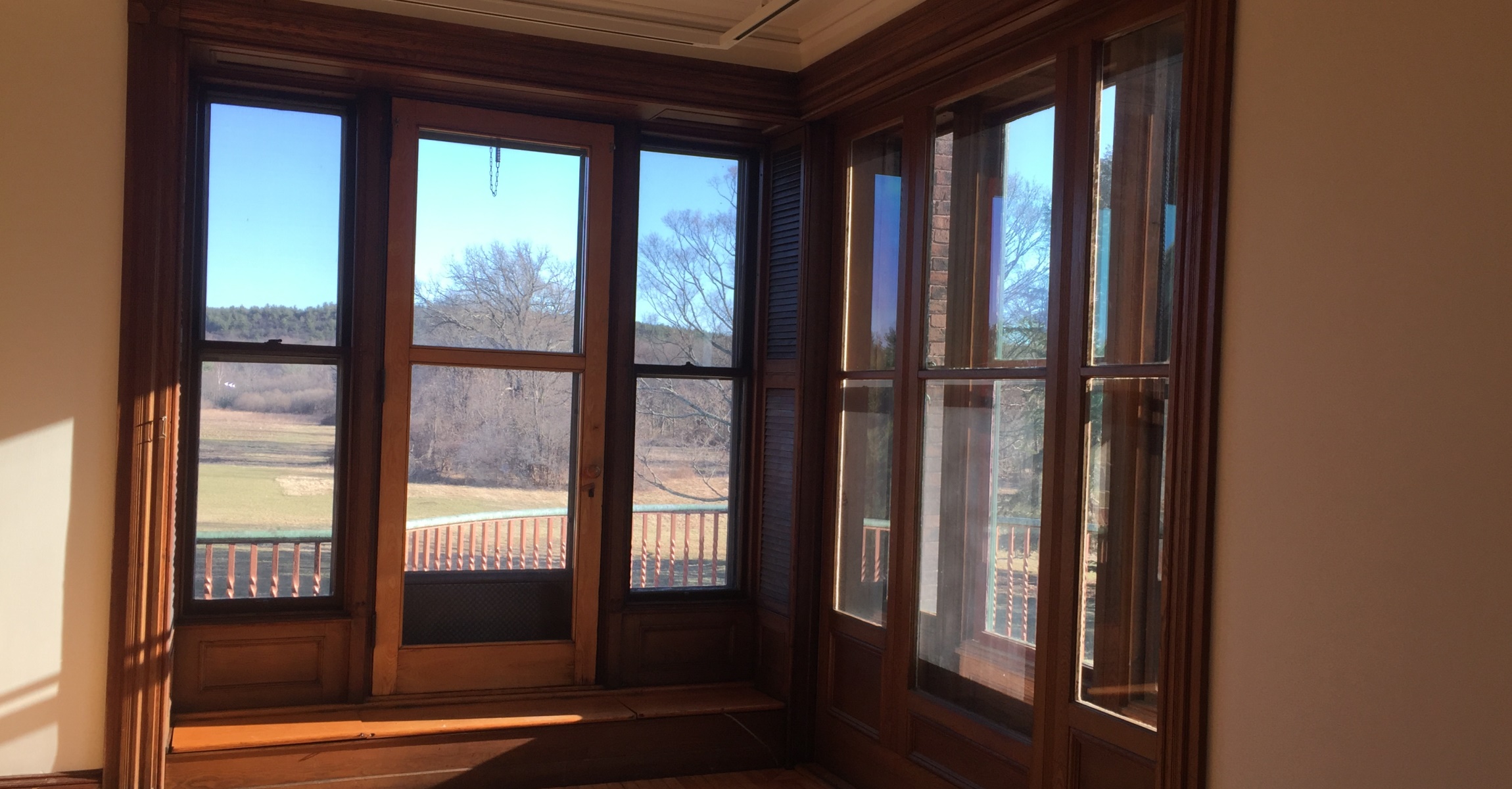 Tall corner windows looking out onto balcony.